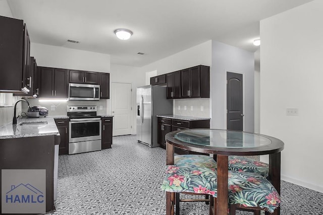 134 Dove Run Dr NE, Ludowici, GA 31316 - kitchen featuring appliances with stainless steel finishes, light stone counters, and backsplash