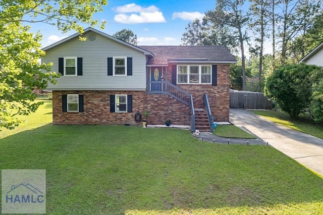 1019 Bacon Rd, Hinesville, GA 31313 - split level home featuring brick siding, driveway, and a front lawn