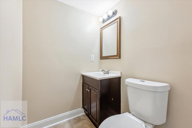 1019 Bacon Rd, Hinesville, GA 31313 - bathroom with toilet, vanity, and baseboards