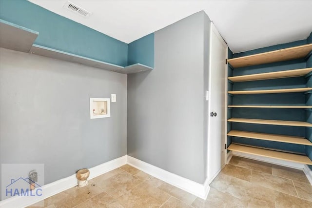 1019 Bacon Rd, Hinesville, GA 31313 - laundry room with washer hookup, baseboards, and light stone finish floors