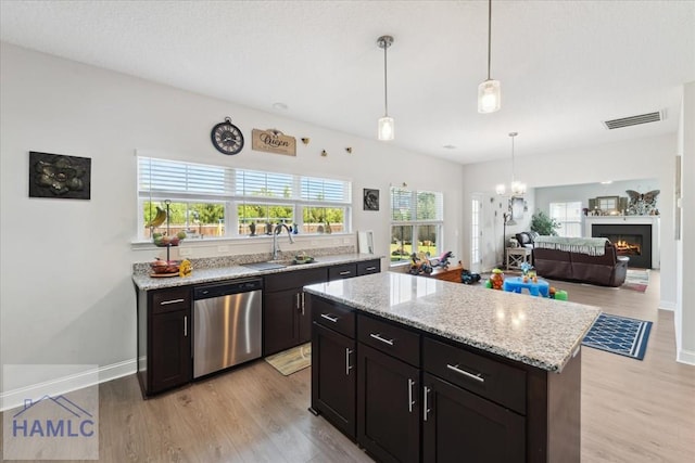 kitchen with visible vents, a sink, dishwasher, and light wood-type flooring