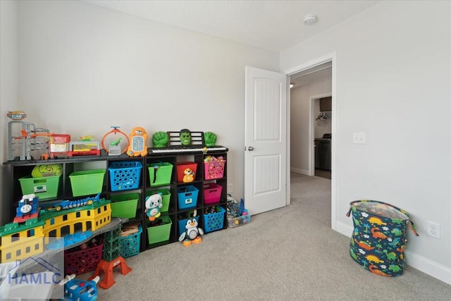 rec room featuring baseboards and carpet flooring