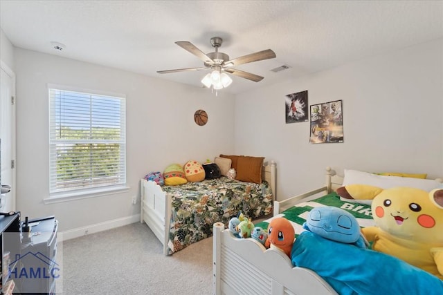 bedroom featuring carpet floors, baseboards, visible vents, and ceiling fan