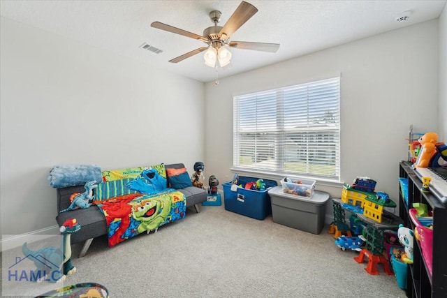 playroom featuring visible vents, a ceiling fan, and carpet