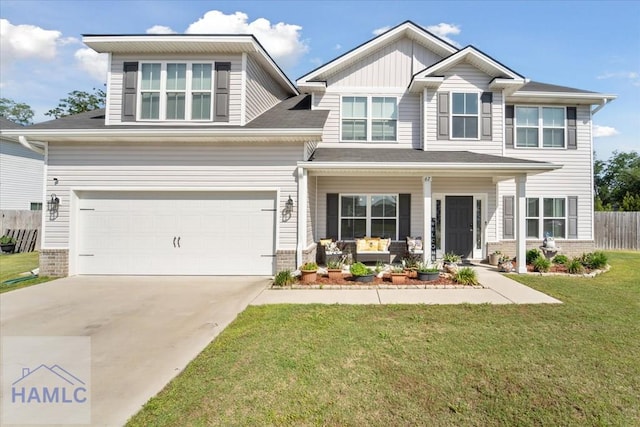 craftsman-style home featuring covered porch, a front yard, driveway, and brick siding