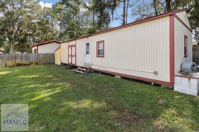 view of side of home with a lawn