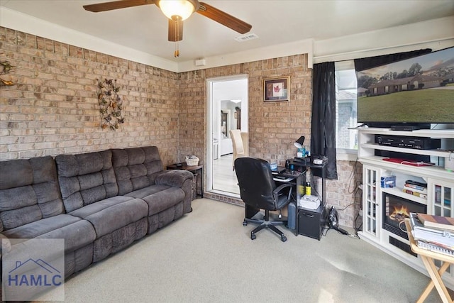 office area with carpet floors and brick wall