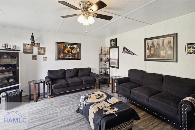 living room featuring hardwood / wood-style floors and ceiling fan