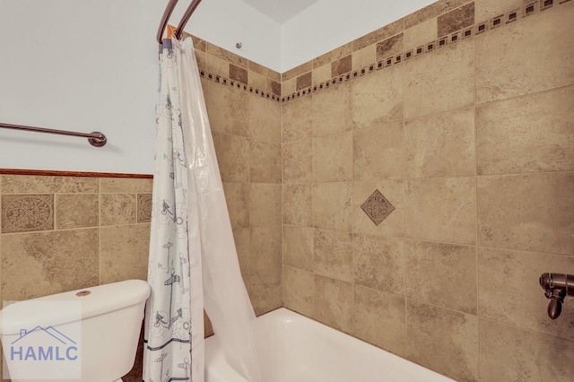 bathroom featuring shower / bath combo and tile walls