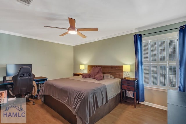 bedroom featuring crown molding, hardwood / wood-style flooring, and ceiling fan