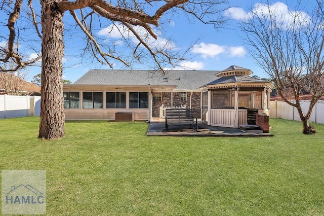 back of house with a gazebo, a yard, a sunroom, and a patio area