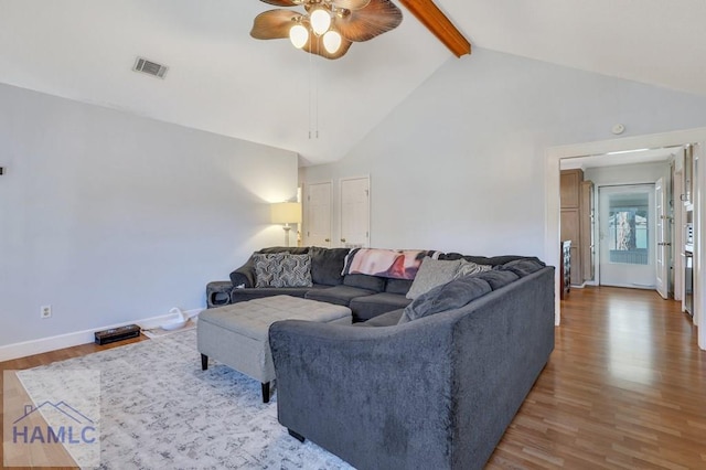 living room with ceiling fan, lofted ceiling with beams, and hardwood / wood-style floors