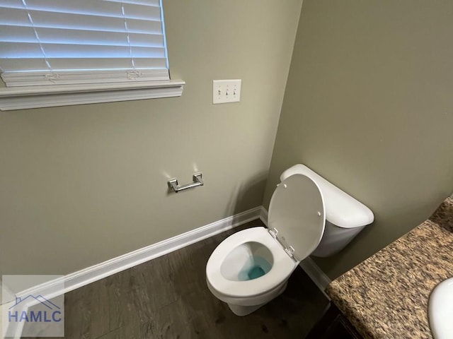 bathroom featuring hardwood / wood-style floors and toilet