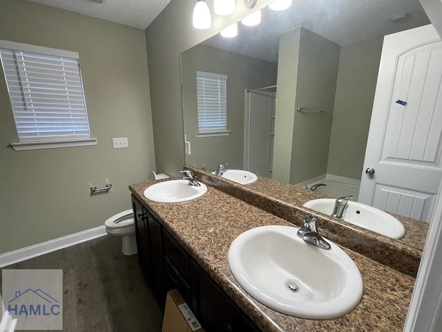 full bathroom featuring independent shower and bath, wood-type flooring, vanity, and toilet