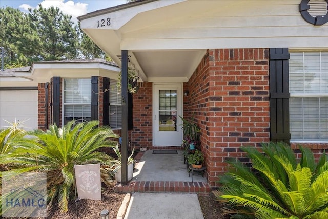 128 W Kenny Dr, Hinesville, GA 31313 - property entrance with brick siding and an attached garage