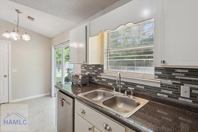 128 W Kenny Dr, Hinesville, GA 31313 - kitchen featuring stainless steel dishwasher, dark countertops, vaulted ceiling, decorative backsplash, and white cabinetry