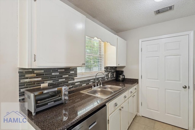 128 W Kenny Dr, Hinesville, GA 31313 - kitchen featuring dishwasher, dark countertops, white cabinets, decorative backsplash, and a textured ceiling