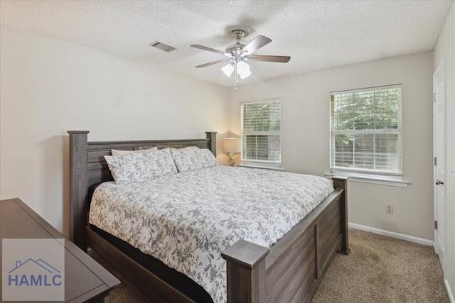 128 W Kenny Dr, Hinesville, GA 31313 - bedroom featuring a textured ceiling, carpet flooring, and a ceiling fan