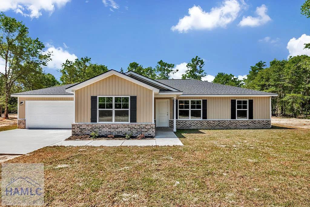 51 Cardinal Ln, Jesup, GA 31545 - ranch-style home featuring a garage, concrete driveway, brick siding, a front lawn, and board and batten siding
