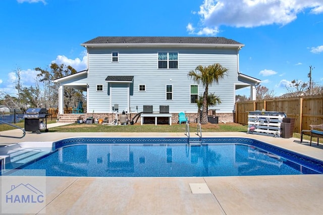 view of swimming pool featuring area for grilling, fence, cooling unit, a fenced in pool, and a patio area