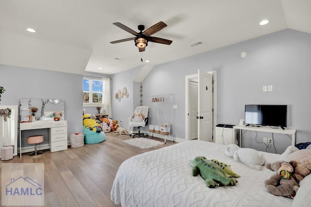 bedroom featuring a ceiling fan, vaulted ceiling, recessed lighting, and wood finished floors