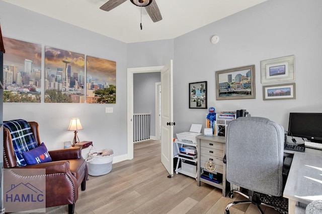 office space featuring baseboards, wood finished floors, and a ceiling fan