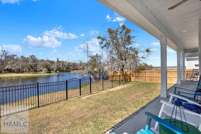 view of yard featuring a water view and a fenced backyard