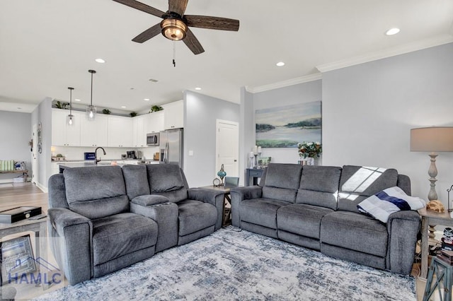 living area featuring recessed lighting, crown molding, and a ceiling fan