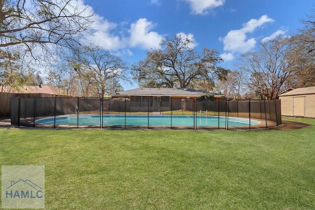 view of pool with an outbuilding, a fenced in pool, a shed, a fenced backyard, and a lawn