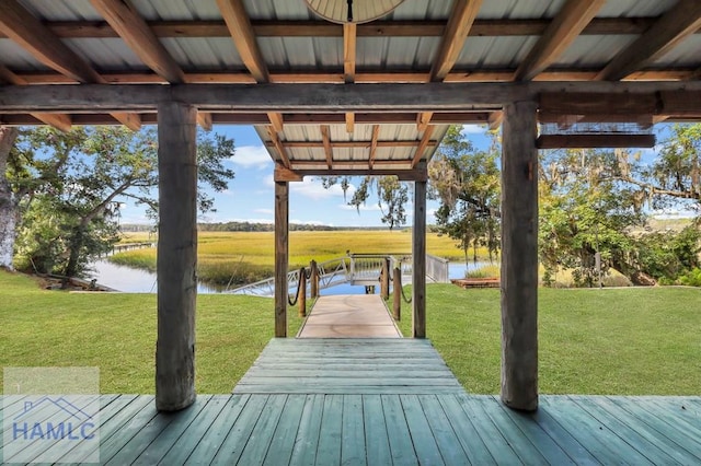 dock area featuring a water view and a lawn