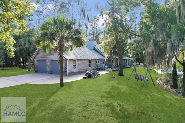 view of side of property featuring a lawn and a garage