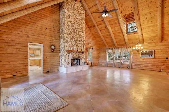 unfurnished living room with beamed ceiling, high vaulted ceiling, wooden ceiling, and wood walls