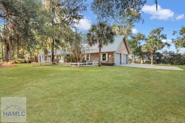 view of front of property featuring a garage and a front lawn