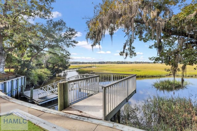 dock area featuring a water view and a rural view