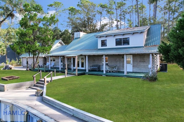 view of front of house featuring a patio, central AC, and a front lawn