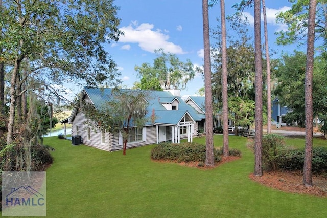 exterior space featuring cooling unit, a water view, and a yard