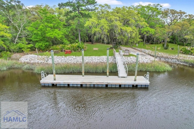 view of dock featuring a lawn and a water view