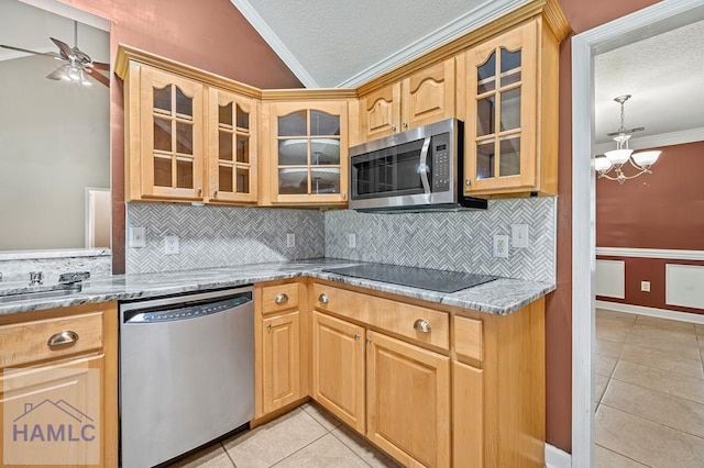 3638 Tibet Rd, Ludowici, GA 31316 - kitchen featuring stainless steel appliances, vaulted ceiling, crown molding, light tile patterned floors, and backsplash