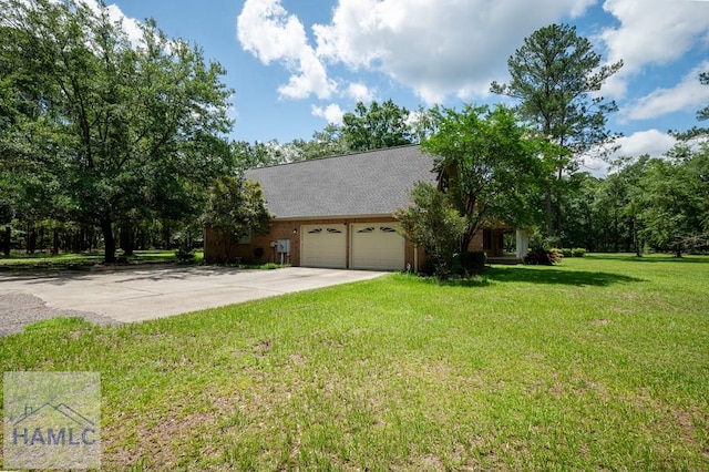 3638 Tibet Rd, Ludowici, GA 31316 - view of property exterior featuring a garage, driveway, and a lawn