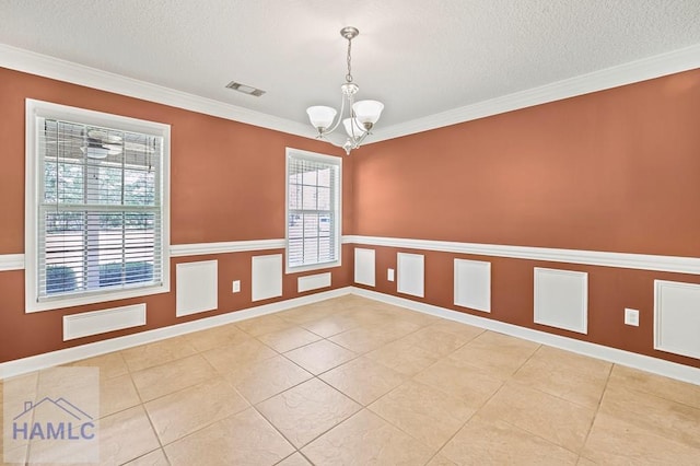 3638 Tibet Rd, Ludowici, GA 31316 - unfurnished room with a chandelier, a textured ceiling, crown molding, and light tile patterned floors