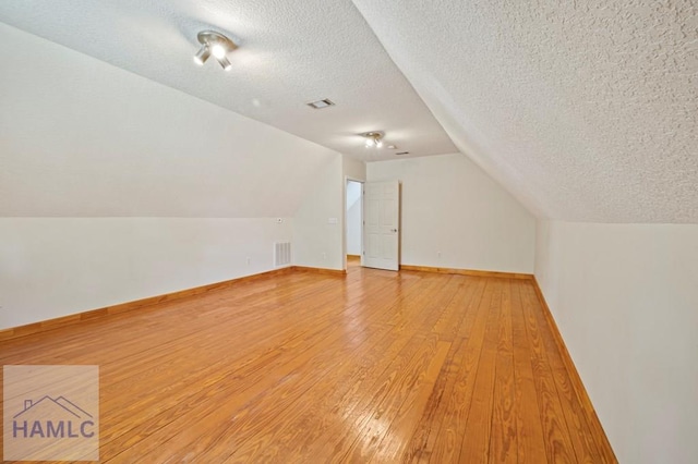 3638 Tibet Rd, Ludowici, GA 31316 - bonus room with light wood-style floors, a textured ceiling, and lofted ceiling