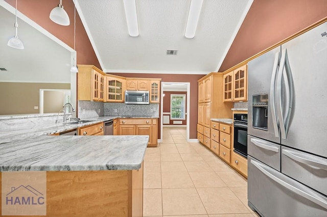 3638 Tibet Rd, Ludowici, GA 31316 - kitchen with appliances with stainless steel finishes, lofted ceiling, decorative backsplash, light tile patterned floors, and glass insert cabinets