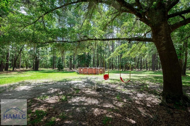 3638 Tibet Rd, Ludowici, GA 31316 - view of yard featuring a hot tub and a wooded view