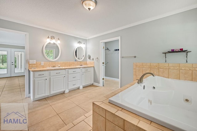 3638 Tibet Rd, Ludowici, GA 31316 - bathroom with double vanity, crown molding, healthy amount of natural light, a tub with jets, and tile patterned floors