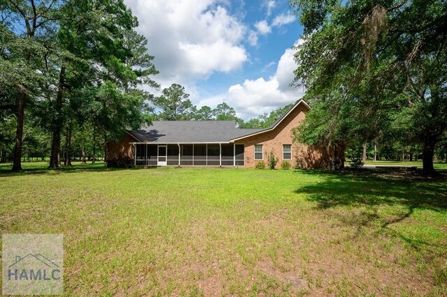 3638 Tibet Rd, Ludowici, GA 31316 - view of grassy yard with a sunroom