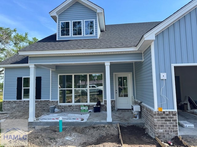 47 Ennis Rd, Pembroke, GA 31321 - doorway to property with a shingled roof, a porch, and board and batten siding