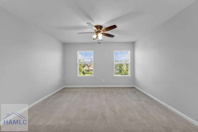 unfurnished room with ceiling fan, baseboards, and carpet