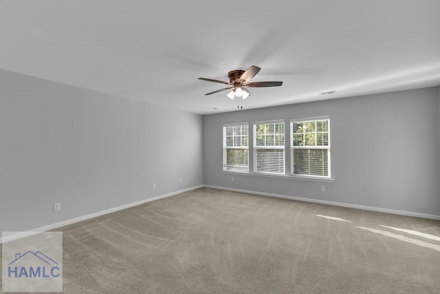carpeted empty room with baseboards and ceiling fan
