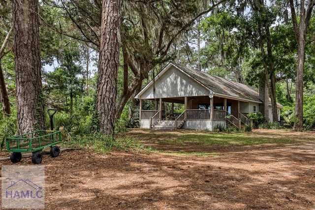 rustic home with covered porch and stairway