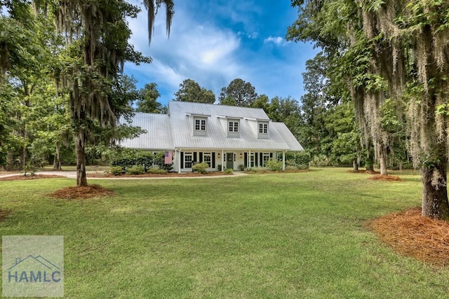 view of front of house with a front lawn, metal roof, and a porch
